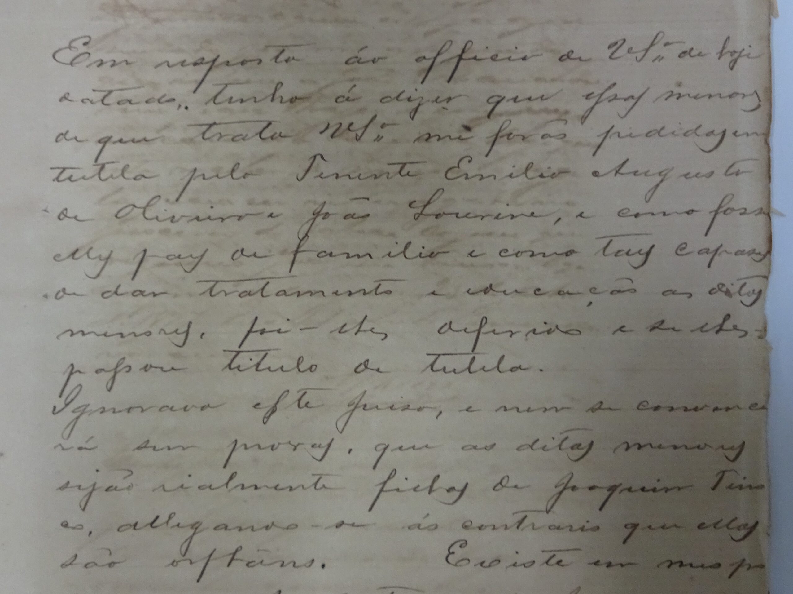 Photograph of page 21 from an 1877 court case document. The yellowed, handwritten page—composed in archaic Portuguese—contains a report by the judge overseeing orphans in Manaus, Brazil. He states that guardianship of Angela and Benedicta was granted to Joao Lourine and Emílio, whom he describes as respectable family men. The judge affirms the girls' orphan status and dismisses a guardianship claim made by their alleged father, Joaquim Tinoco.